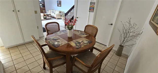 a living room with furniture and stairs