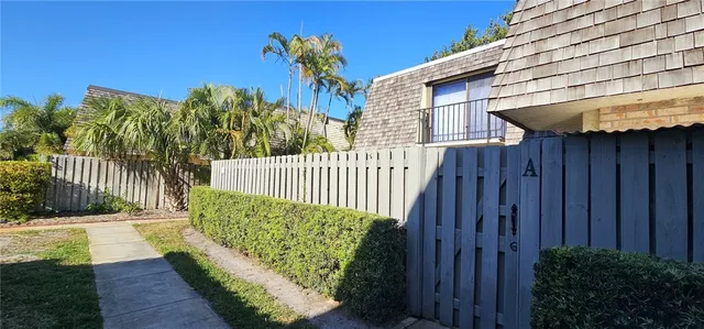a view of a house with a wooden fence