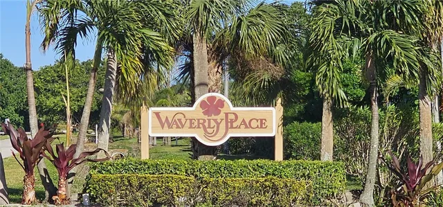 a view of a yard with plants and a fountain