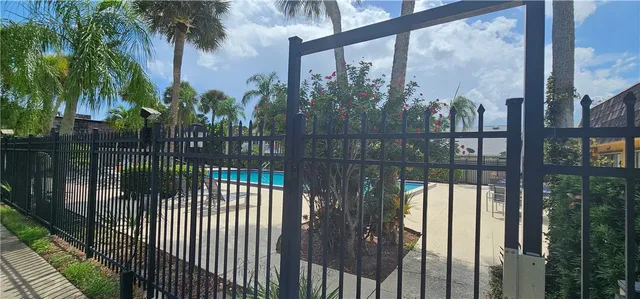 a view of a house with a small yard and wooden fence