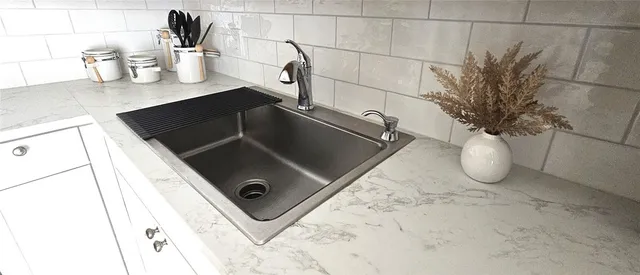 a kitchen with stainless steel appliances granite countertop a refrigerator sink stove and white cabinets