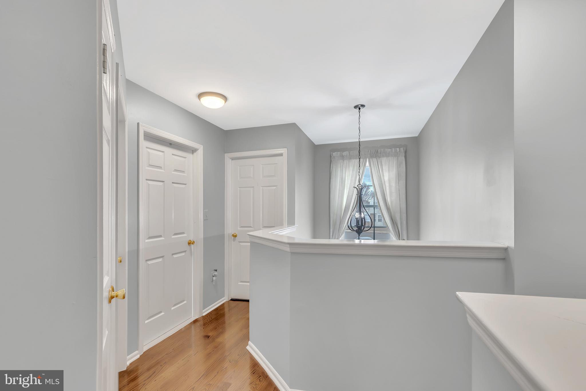 44 Kristopher Drive Hamilton, NJ 08620 - Photo 13 of 19 a view of a hallway with windows and chandelier