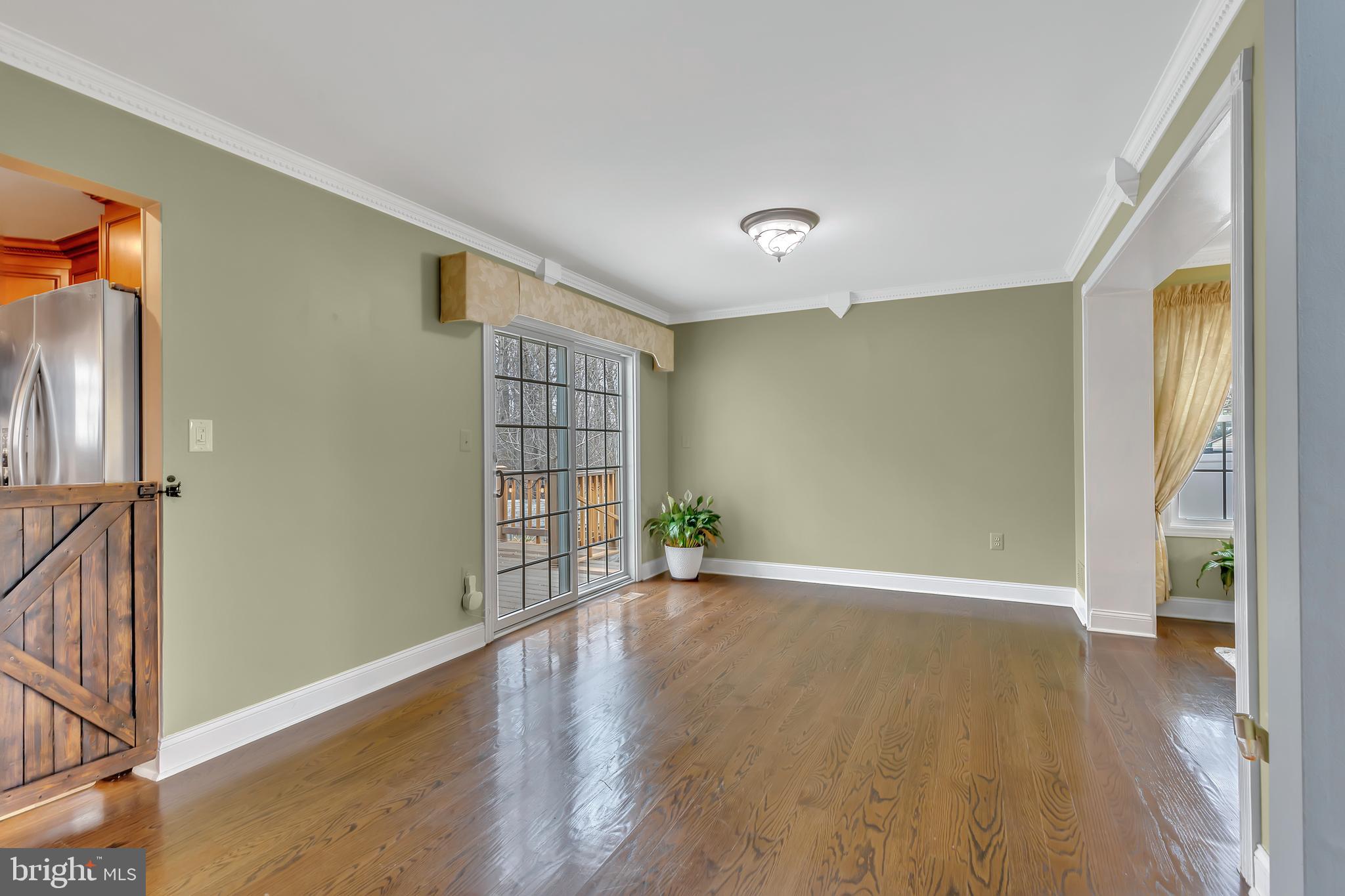 44 Kristopher Drive Hamilton, NJ 08620 - Photo 5 of 19 a view of an empty room with wooden floor and a window