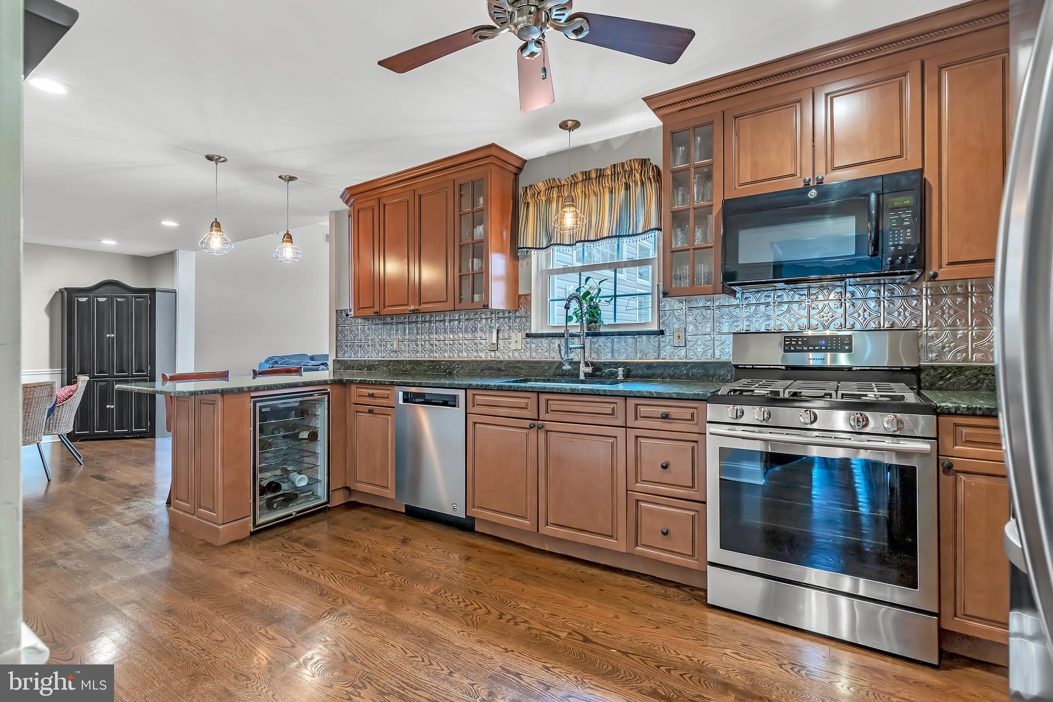 44 Kristopher Drive Hamilton, NJ 08620 - Photo 6 of 19 a kitchen with stainless steel appliances granite countertop a stove top oven a sink and a microwave