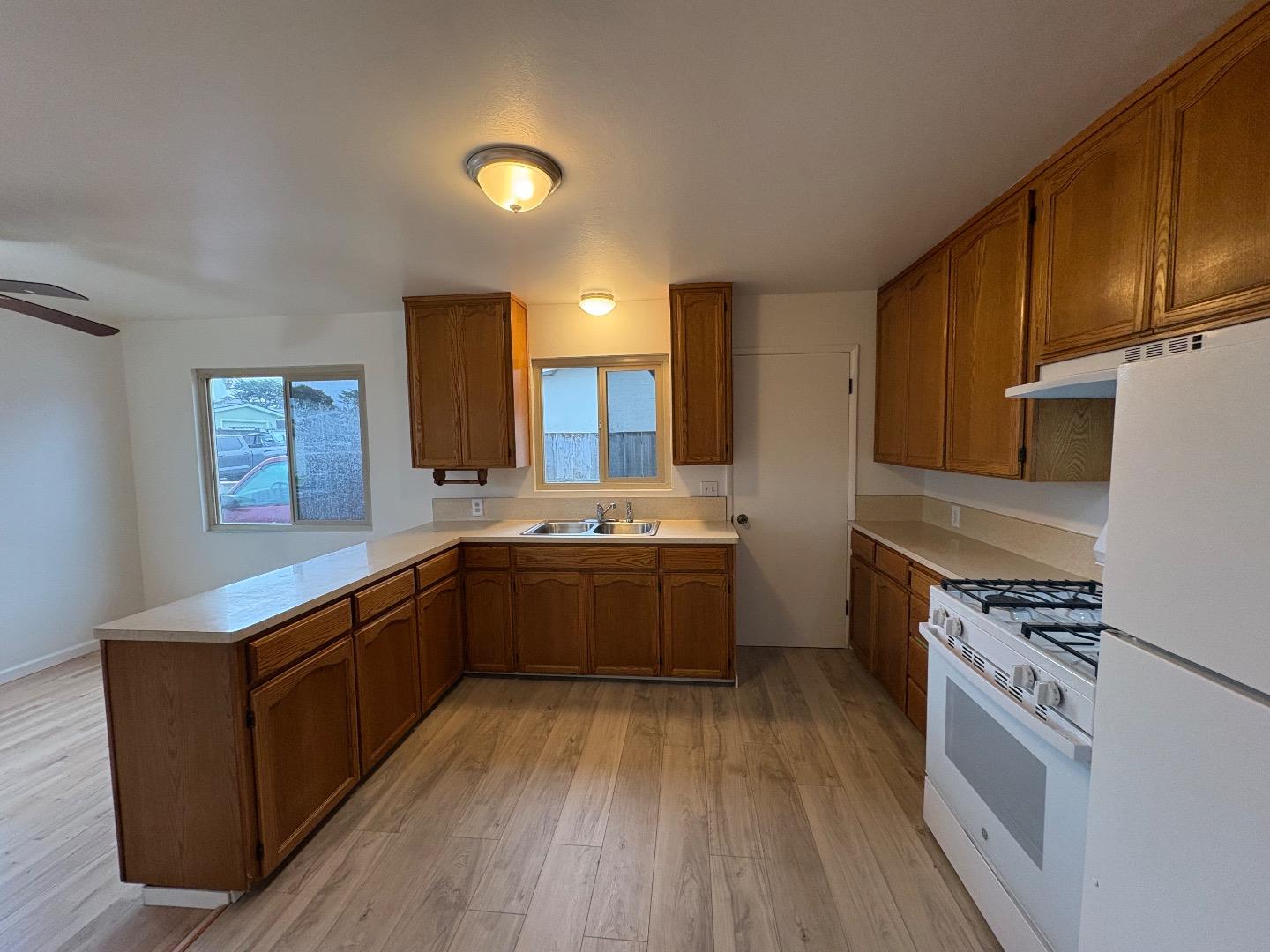 1675 Luxton Street Seaside, CA 93955 - Photo 13 of 33 a kitchen with stainless steel appliances granite countertop a stove a sink dishwasher and a refrigerator