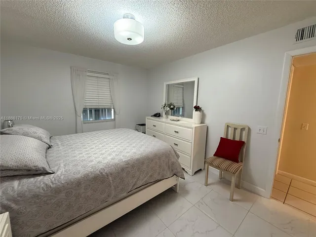 a bedroom with a bed and a chair
