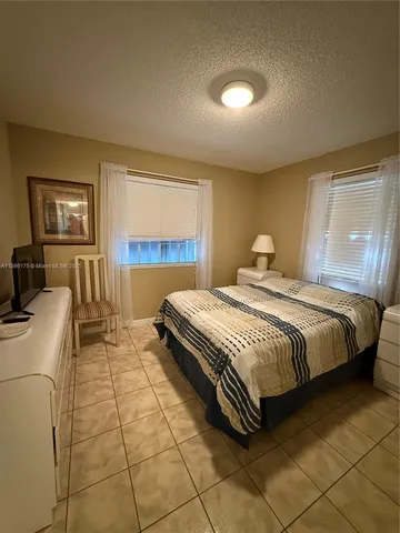 a spacious bedroom with a bed and a couch