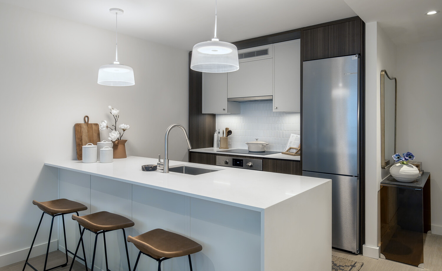 335 8th Avenue, Unit 418 Manhattan, NY 10001 - Photo 3 of 13 a kitchen with a table a refrigerator and cabinets