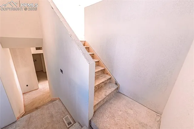 an empty room with windows and closet