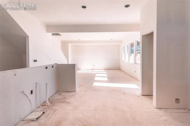 a large white bed in a white room