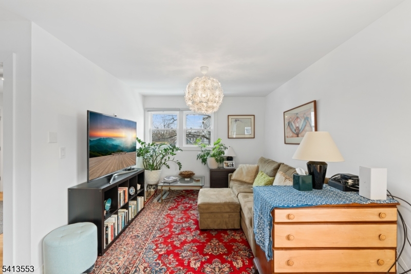 5 Washington Street Montclair, NJ 07042 - Photo 11 of 18 a living room with furniture a chandelier and a flat screen tv
