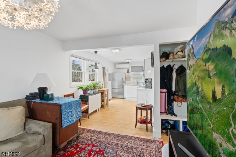 5 Washington Street Montclair, NJ 07042 - Photo 14 of 18 a living room with furniture floor to ceiling window and a flat screen tv
