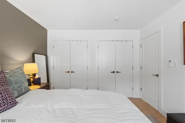 a bedroom with a bed and a mirror