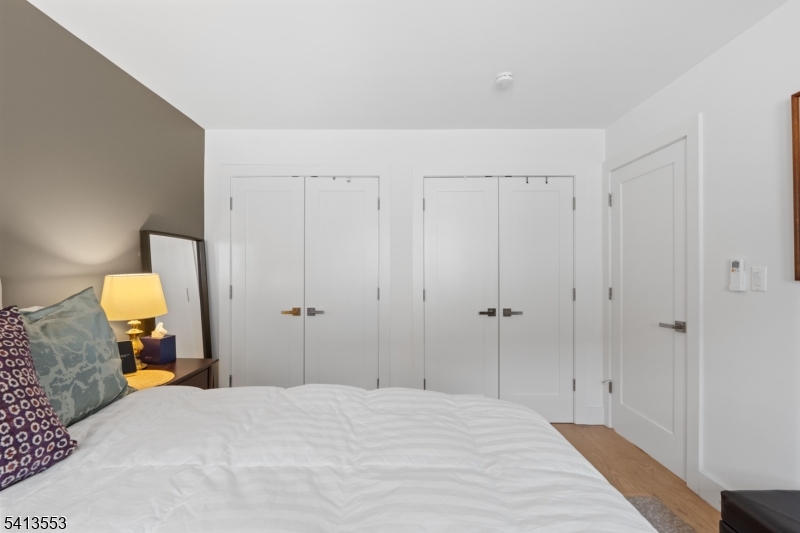 5 Washington Street Montclair, NJ 07042 - Photo 3 of 18 a bedroom with a bed and a mirror