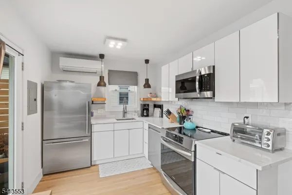 a kitchen with a refrigerator sink and microwave