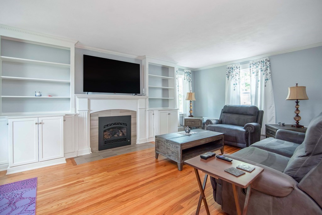 15 Three Rivers Road Wilbraham, MA 01095 - Photo 21 of 37 a living room with furniture a fireplace and a flat screen tv
