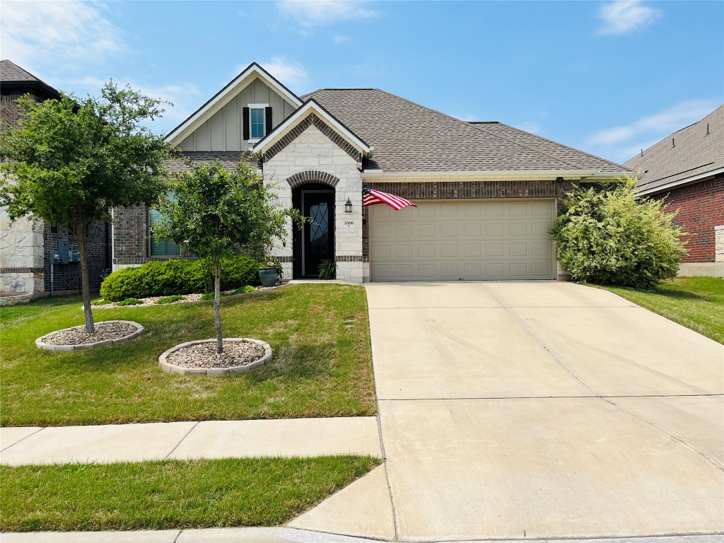 a front view of a house with garden