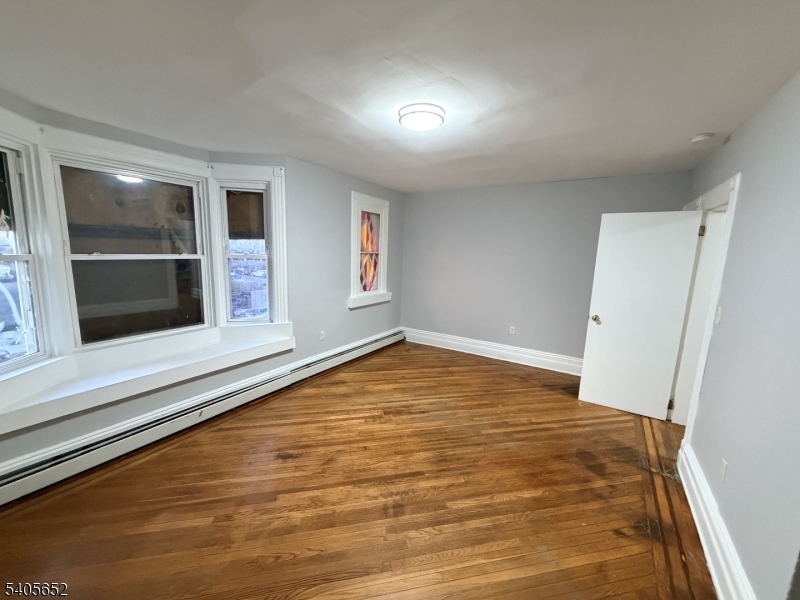 213 North 7th Street Newark, NJ 07107 - Photo 13 of 20 a view of empty room with wooden floor and cabinet