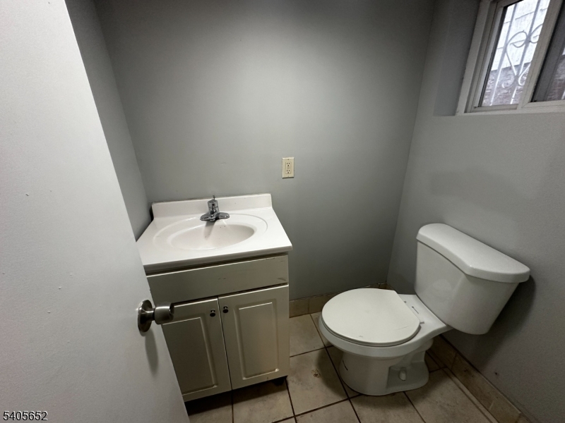 213 North 7th Street Newark, NJ 07107 - Photo 16 of 20 a bathroom with a toilet sink and mirror