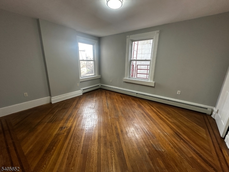 213 North 7th Street Newark, NJ 07107 - Photo 10 of 20 a view of an empty room with wooden floor and a window