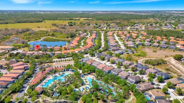 a front view of a multi story residential apartment building with yard and outdoor seating