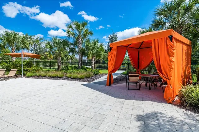 a view of a swimming pool with an outdoor seating