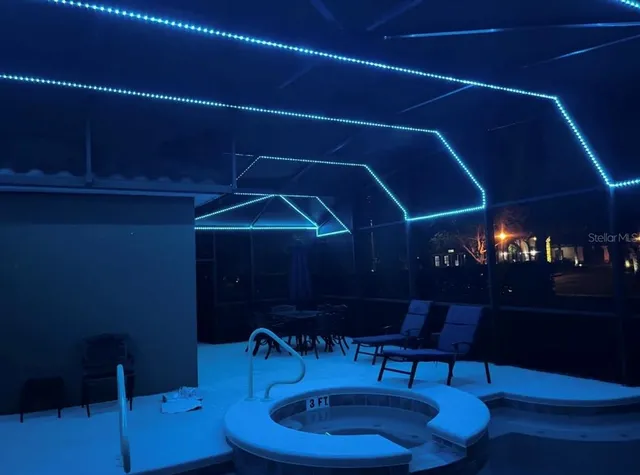 a room with a table chairs and a potted plant