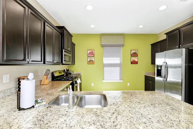 a kitchen with refrigerator and faucet
