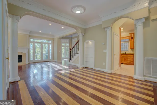 a view of a hallway with wooden floor and staircase