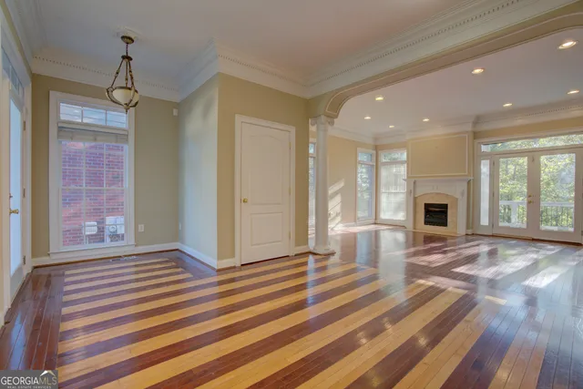 a view of a livingroom with wooden floor and a fireplace
