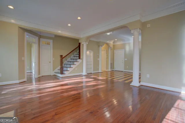 a view of a room with wooden floor and stairs