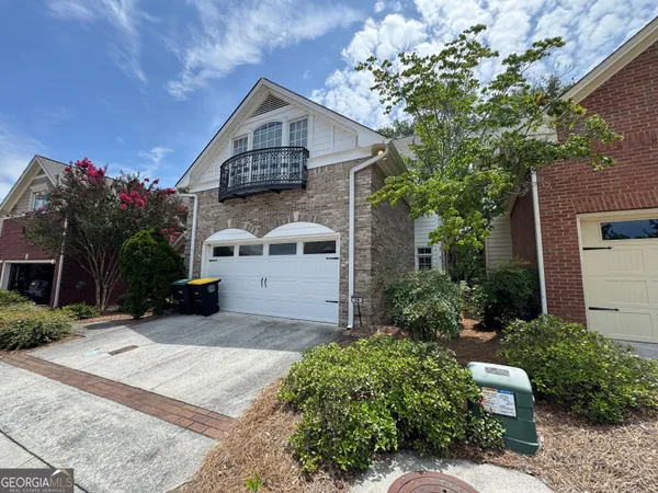 a front view of a house with a yard and a garage