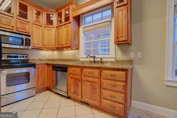 a kitchen with stainless steel appliances granite countertop a stove and a sink
