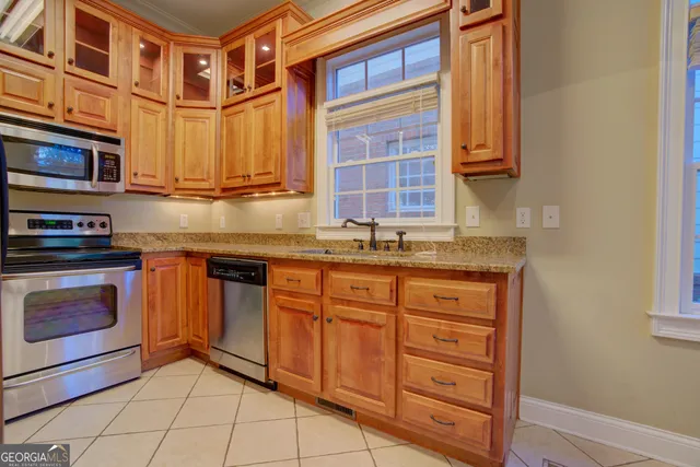 a kitchen with stainless steel appliances granite countertop a stove and a sink