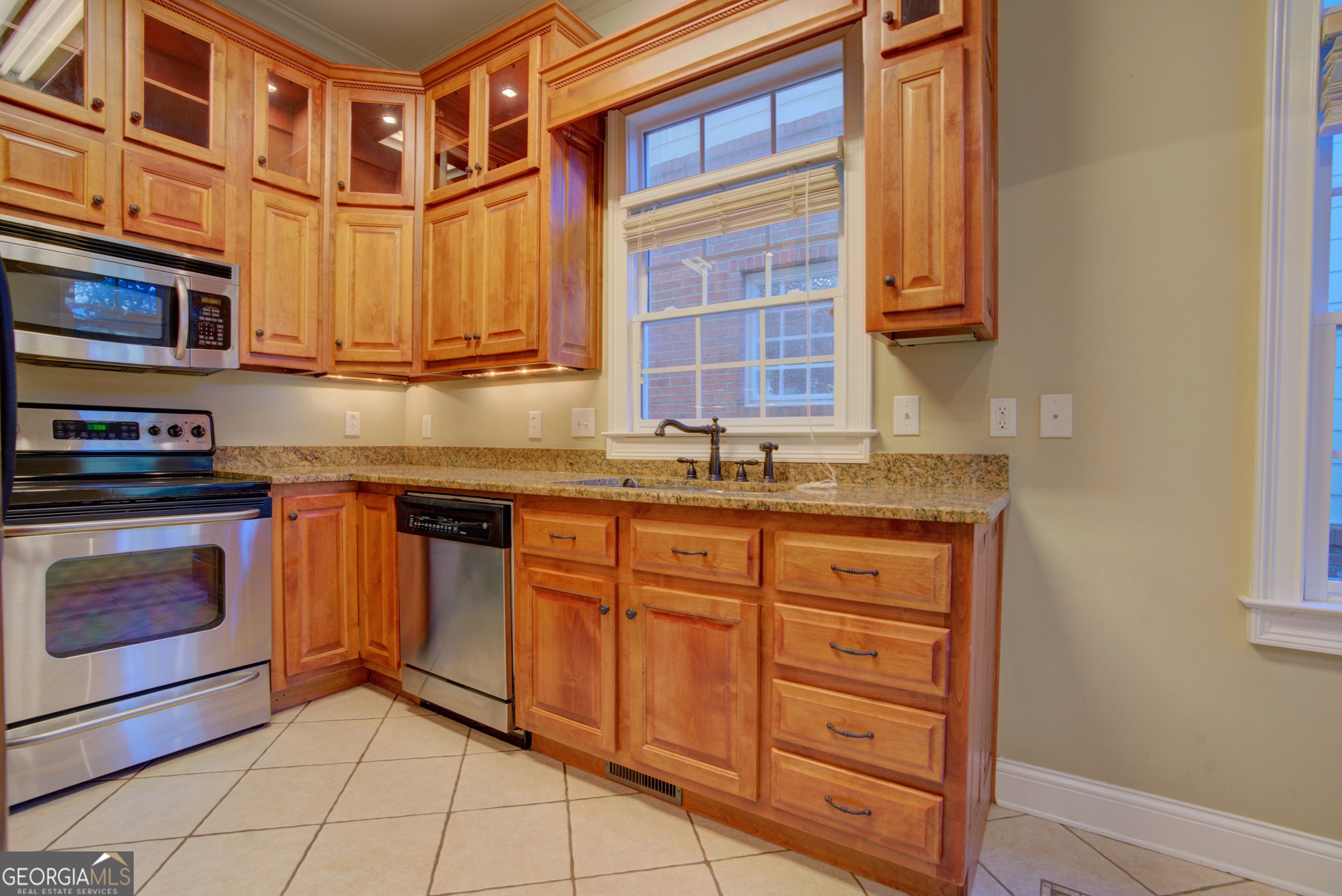 29 Pear Street Rome, GA 30161 - Photo 21 of 55 a kitchen with stainless steel appliances granite countertop a stove and a sink