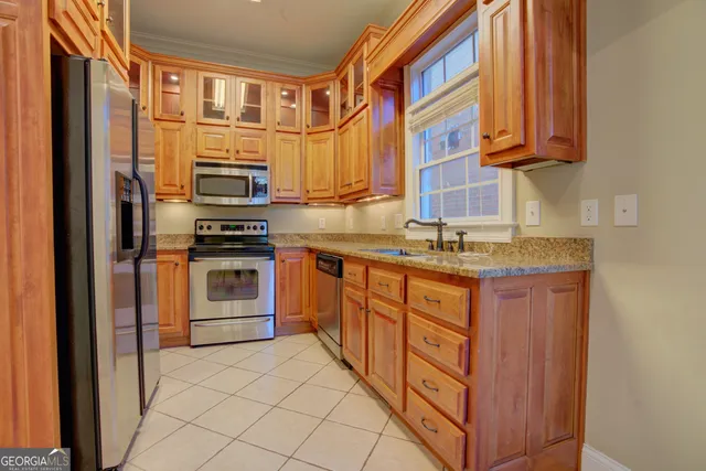 a kitchen with stainless steel appliances granite countertop a stove and a sink