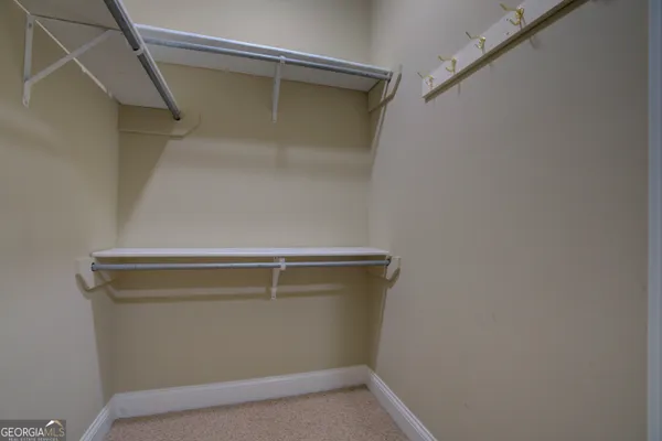 a spacious bathroom with a granite countertop sink toilet a large mirror and shower