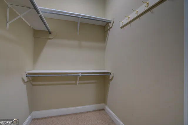 a spacious bathroom with a granite countertop sink toilet a large mirror and shower