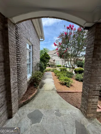 a view of a house that has a flower garden