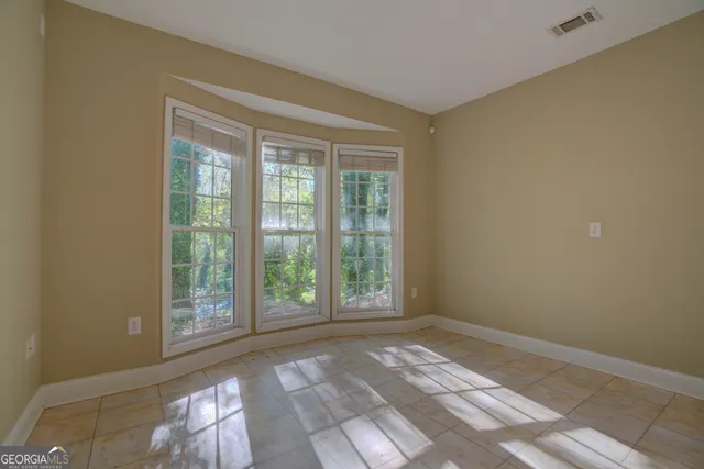 a view of a porch with a table and chairs