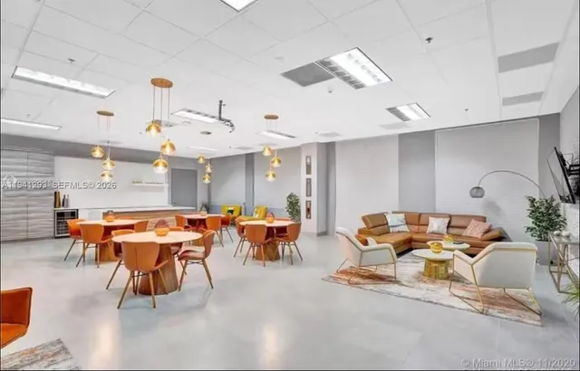 a room with furniture pool table and windows