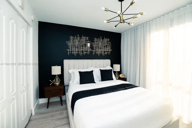 a bedroom with a bed and a chandelier