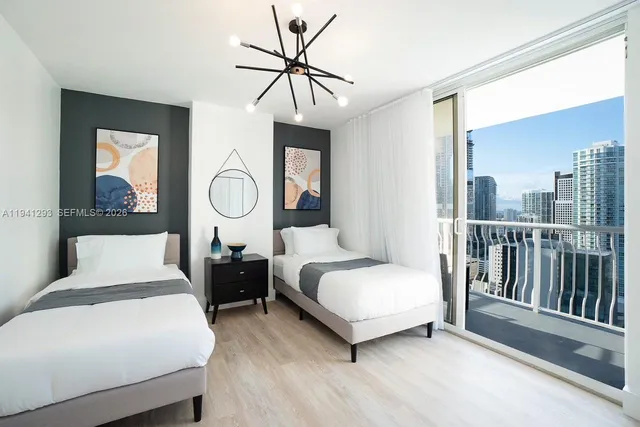 a bedroom with bed and a chandelier