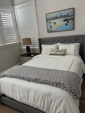 a bed room with a bed window and a chair