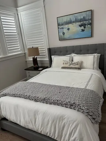 a bed room with a bed window and a chair