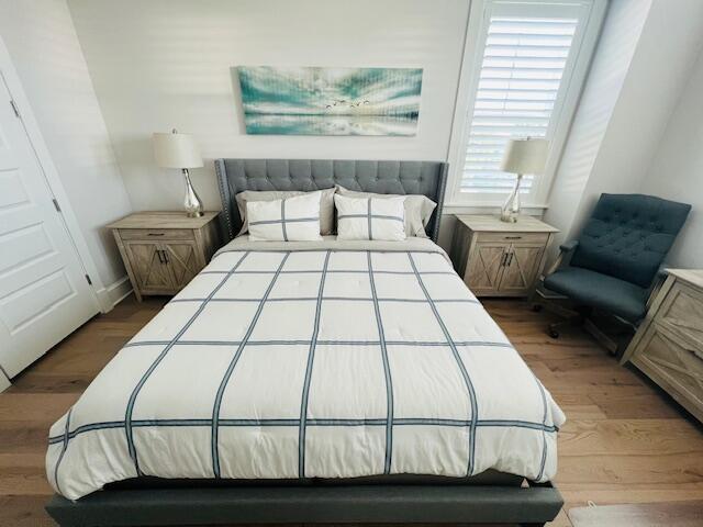 11 East Crabbing Hole Ln Inlet Beach Inlet Beach, FL 32461 - Photo 22 of 34 a bedroom with a bed and wooden floor