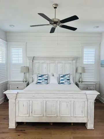 a bedroom with a bed a dresser and a window