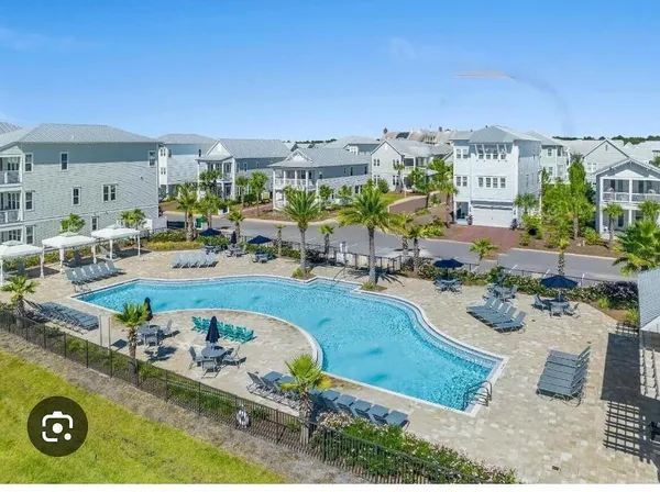 an aerial view of a house with yard swimming pool and outdoor seating