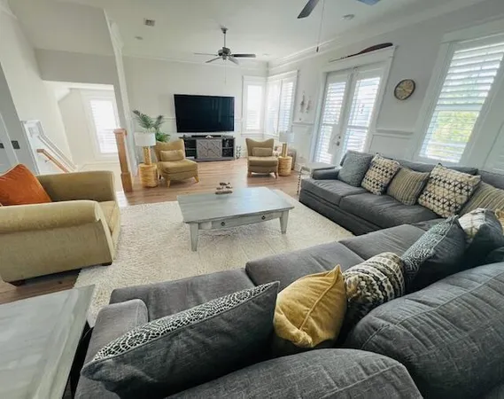 a living room with furniture and a flat screen tv