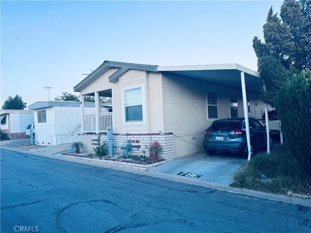 a view of a house with wooden deck and furniture